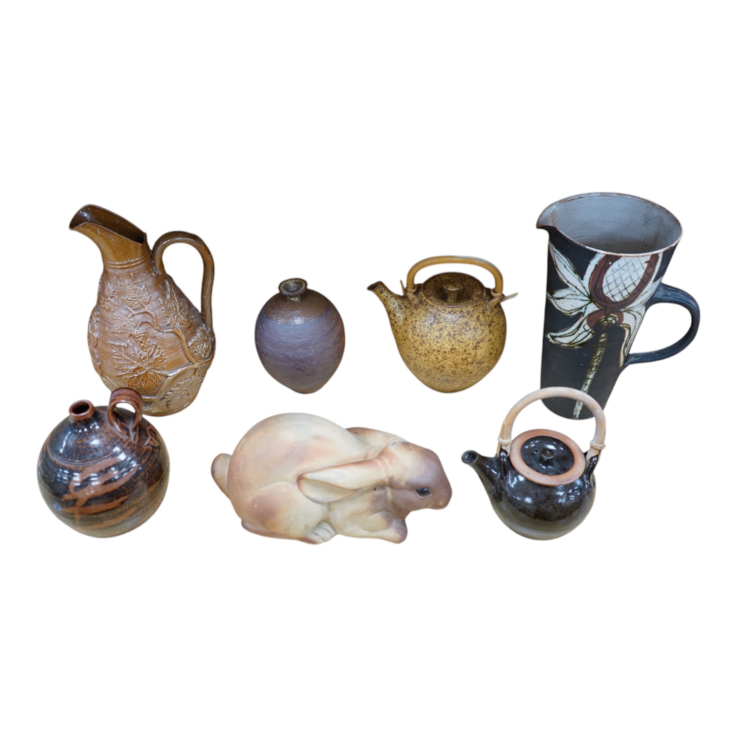 A collection of Studio pottery to include teapots and jugs, together with a pottery model of a rabbit, indistinctly signed to the base, and a French salt glazed wine jug, largest 33cm high. Condition - fair to good